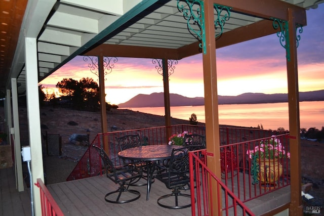 deck featuring outdoor dining space and a mountain view