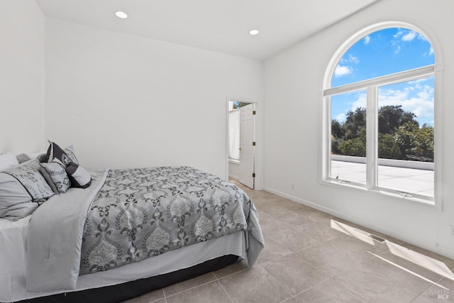 bedroom featuring recessed lighting, light tile patterned flooring, and baseboards