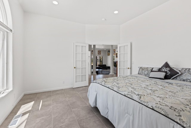 bedroom featuring french doors, light tile patterned floors, recessed lighting, visible vents, and baseboards