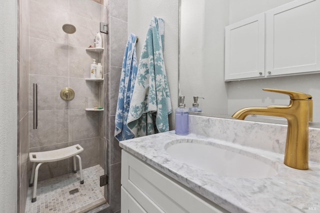 bathroom with a stall shower and vanity