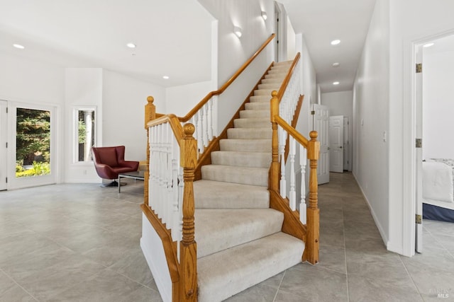 stairs with recessed lighting and baseboards