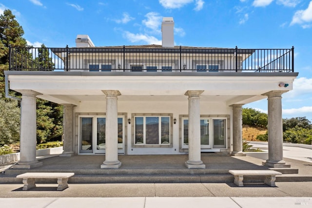 back of house with a balcony