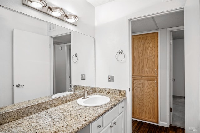 bathroom with visible vents, wood finished floors, and vanity