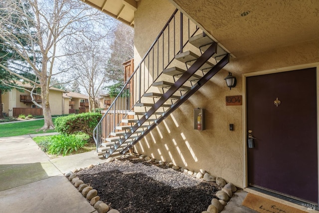 entrance to property featuring stucco siding