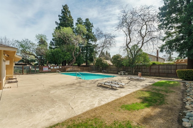 pool featuring a patio and a fenced backyard