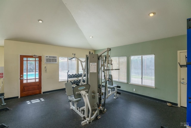 interior space with lofted ceiling, recessed lighting, baseboards, and a wall mounted air conditioner