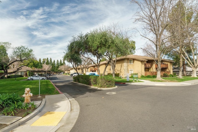 view of street featuring a residential view, curbs, and sidewalks