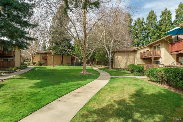 view of property's community featuring a yard