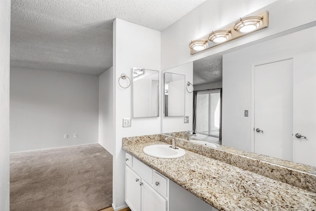 bathroom with a textured ceiling and vanity