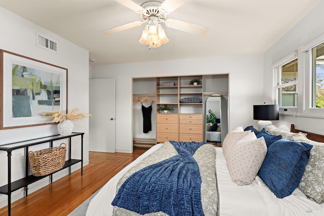 bedroom with visible vents, ceiling fan, and wood finished floors