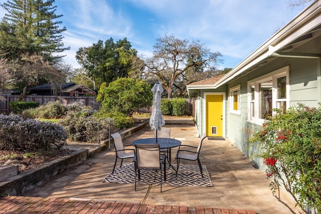 view of patio featuring fence and outdoor dining space