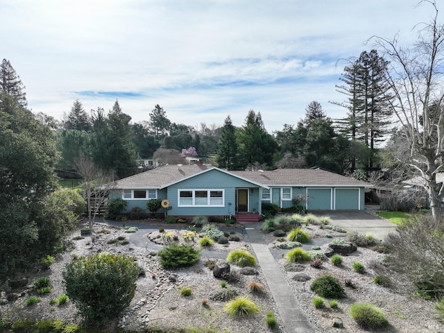 ranch-style house featuring an attached garage and driveway