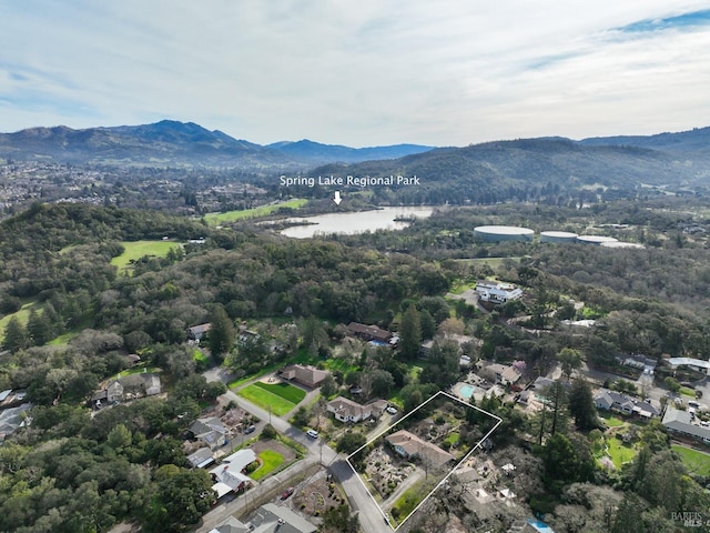 birds eye view of property with a wooded view and a water and mountain view