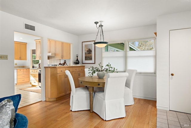 dining space featuring visible vents and light wood finished floors