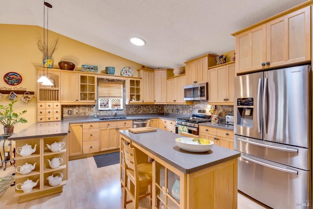 kitchen featuring appliances with stainless steel finishes, vaulted ceiling, light brown cabinets, open shelves, and backsplash