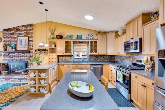 kitchen with open shelves, vaulted ceiling, stainless steel appliances, and light brown cabinetry