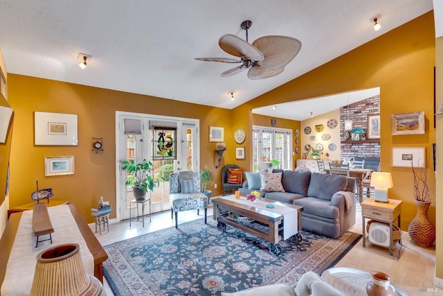 living room featuring lofted ceiling and a ceiling fan