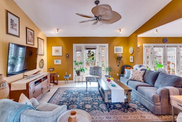 living area with vaulted ceiling, french doors, a ceiling fan, and baseboards