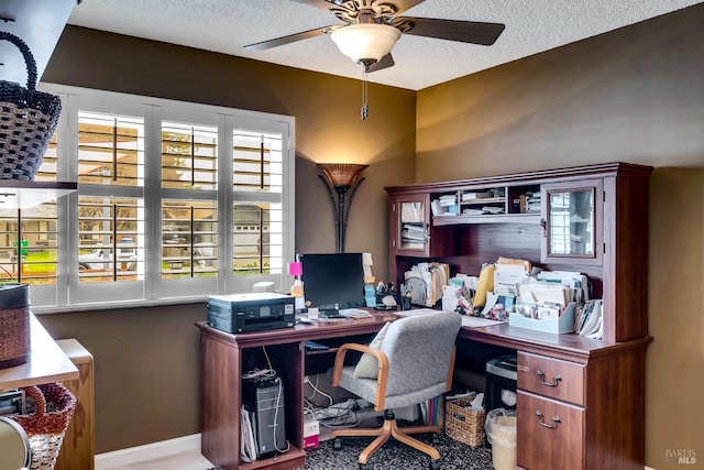 home office with ceiling fan and a textured ceiling