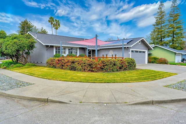 ranch-style home featuring an attached garage, driveway, a front lawn, and stucco siding