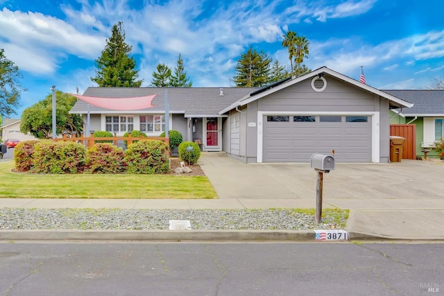 single story home featuring an attached garage, driveway, and a front yard