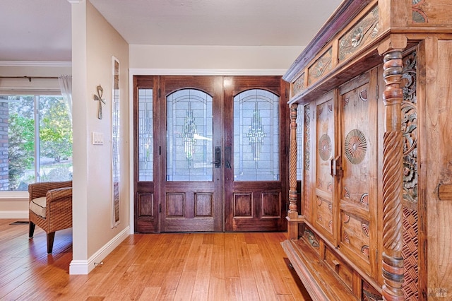 entrance foyer with baseboards and light wood-style floors