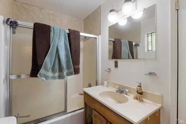 full bathroom featuring combined bath / shower with glass door and vanity