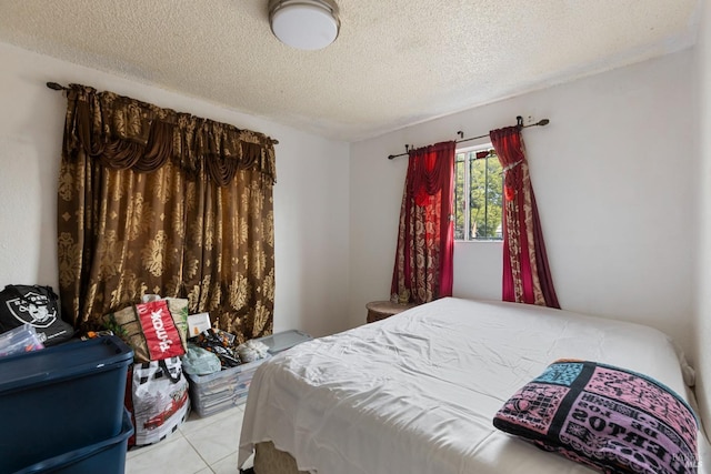 tiled bedroom with a textured ceiling