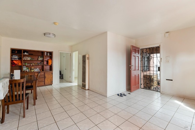 dining room with baseboards and light tile patterned flooring