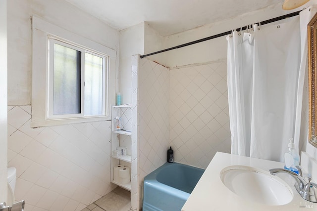 full bath featuring toilet, shower / tub combo, vanity, tile walls, and tile patterned floors