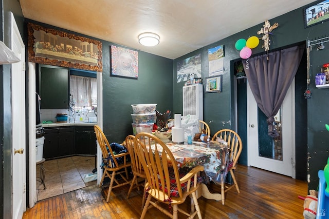 dining space with wood-type flooring