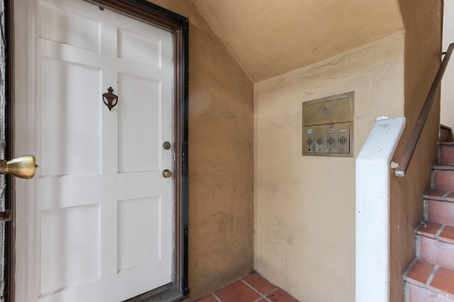 property entrance with stucco siding