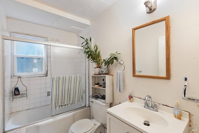 full bath featuring vanity, toilet, and bath / shower combo with glass door