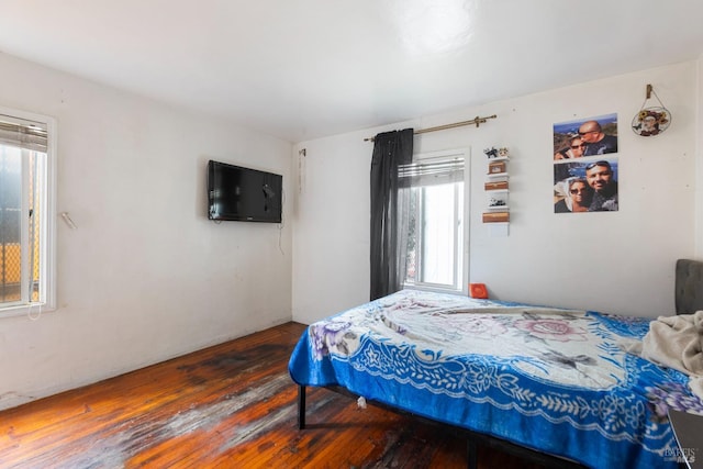 bedroom with hardwood / wood-style flooring