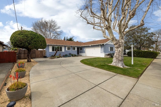 ranch-style house with a garage, concrete driveway, fence, a front lawn, and stucco siding