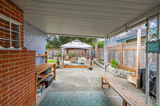 view of patio featuring a fenced backyard and a gazebo