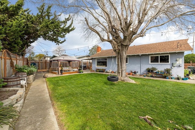 view of yard featuring a gazebo, a patio, and a fenced backyard