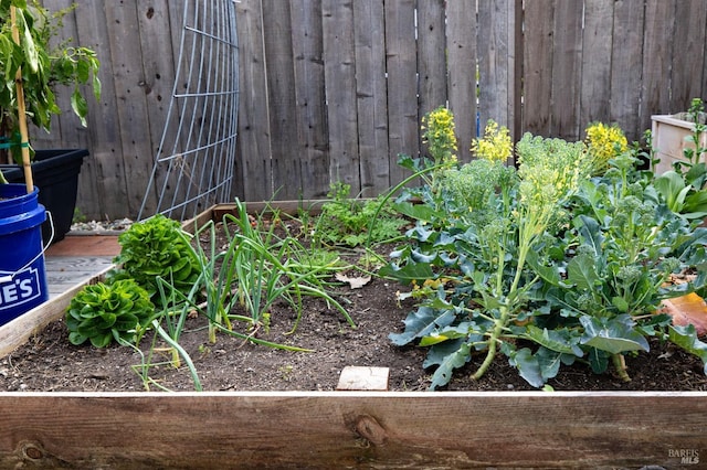 exterior details featuring a garden and fence