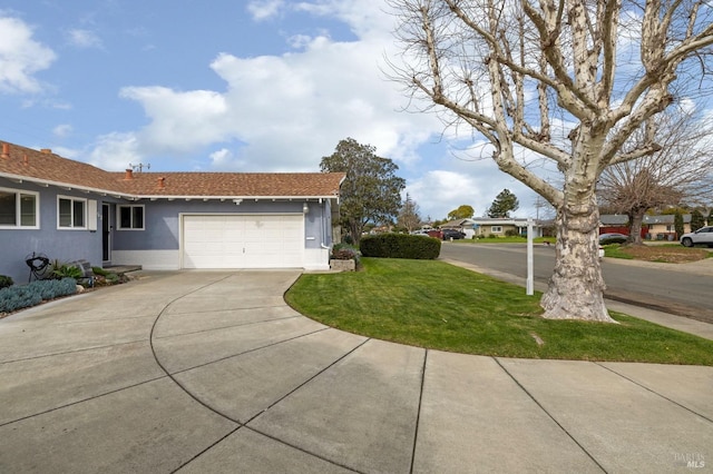 exterior space featuring a garage, concrete driveway, a lawn, and stucco siding