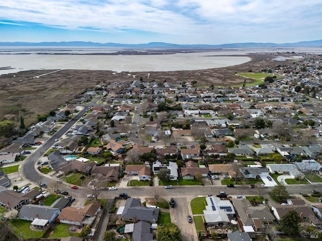 aerial view featuring a water and mountain view and a residential view