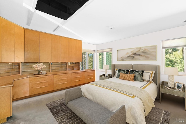 bedroom featuring light carpet and vaulted ceiling