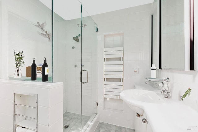 full bathroom with a stall shower, radiator, tile walls, and decorative backsplash