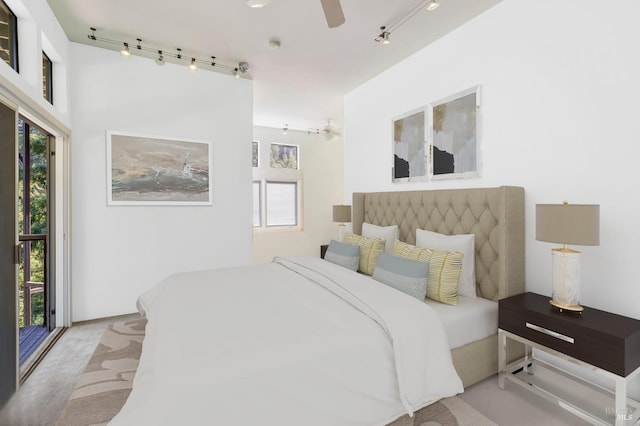 carpeted bedroom featuring multiple windows, ceiling fan, and track lighting