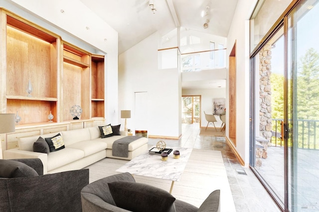 living area featuring high vaulted ceiling, visible vents, and baseboards