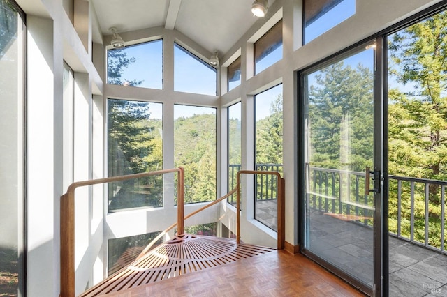 unfurnished sunroom featuring vaulted ceiling