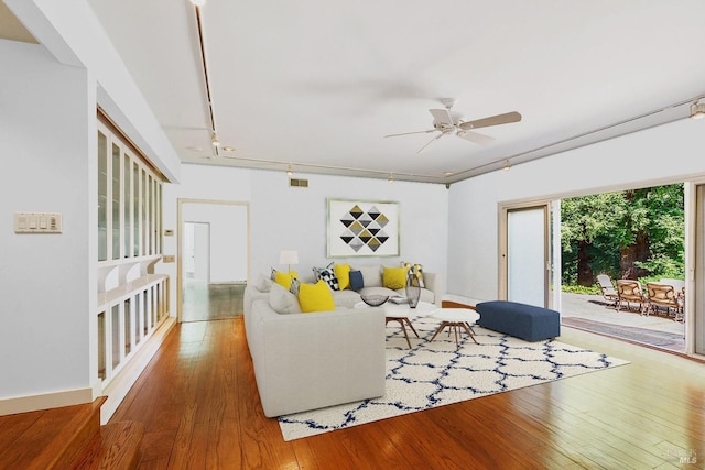 living area featuring hardwood / wood-style flooring, ceiling fan, visible vents, and track lighting