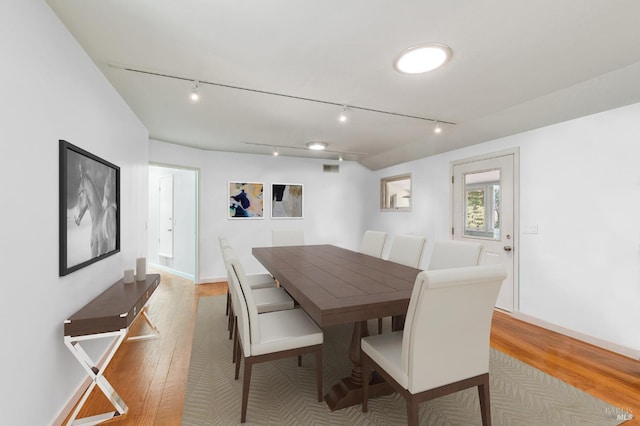 dining area featuring light wood-type flooring and baseboards