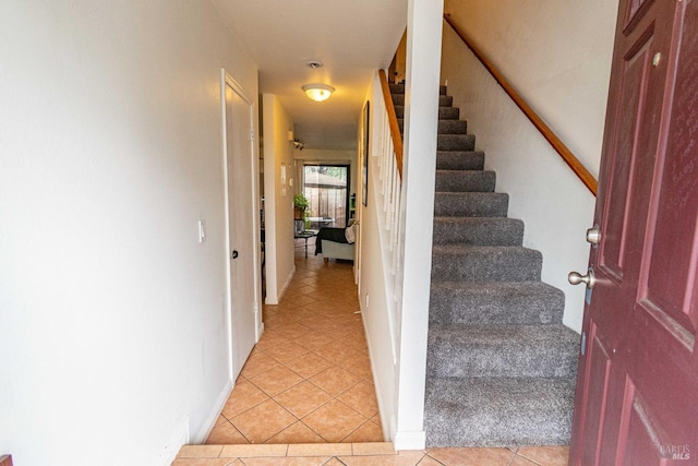 stairway featuring tile patterned flooring