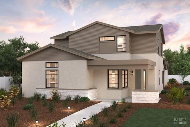 view of front of home with fence and stucco siding