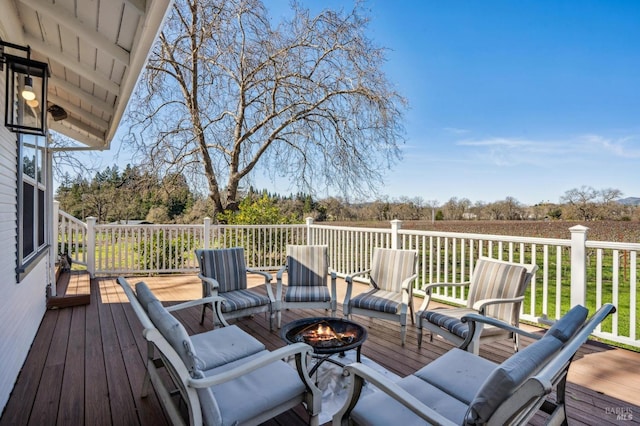 wooden terrace featuring a fire pit